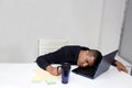 Man works in his office with a lot of stress having a headache with a migraine and suffering from tiredness and burnout Royalty Free Stock Photo