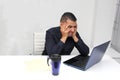 Man works in his office with a lot of stress having a headache with a migraine and suffering from tiredness and burnout Royalty Free Stock Photo