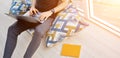 Man works at home on pillows on balcony on sunny day