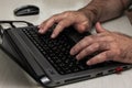 A man works on a laptop. Men`s hands are typing on a laptop closeup. Business concept, office concept