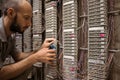 Man works with pliers in the server room of an analog telephone exchange. The specialist fixes the problem of communication. Royalty Free Stock Photo