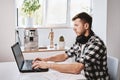 Man works remotely at home office with laptop Royalty Free Stock Photo