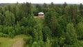 Man works with a saw. renovates the house. two-storey wooden house hill forest