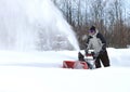 A man works snow blowing machine Royalty Free Stock Photo