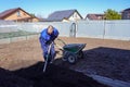 A man works in a vegetable garden in early spring