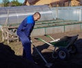 A man works in a vegetable garden in early spring