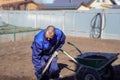 A man works in a vegetable garden in early spring