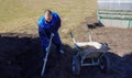 A man works in a vegetable garden in early spring