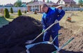 A man works in a vegetable garden in early spring