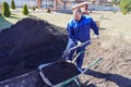 A man works in a vegetable garden in early spring