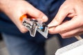 A man works with a wire stripper in his hands and a cable. Hands only. Horizontal orientation. Royalty Free Stock Photo