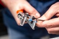 A man works with a wire stripper in his hands and a cable. Hands only. Horizontal orientation. Royalty Free Stock Photo