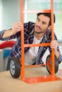 Man in workshop inspecting sack truck