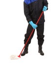 Man in workwear cleaning with mop. Royalty Free Stock Photo