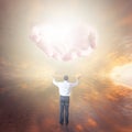 Man worshiping God. Hands with light coming from the sky Royalty Free Stock Photo