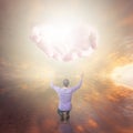 Man worshiping God. Hands with light coming from the sky Royalty Free Stock Photo