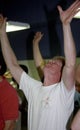 Man worships God with hands raised during a church servive Royalty Free Stock Photo