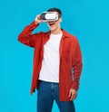 Man, wow and VR or futuristic glasses for gaming software, digital world and fantasy vision on a blue background Royalty Free Stock Photo