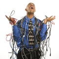 Man wrapped in cables. Royalty Free Stock Photo