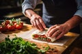 a man wrapping bruschetta with mozzarella in cling film