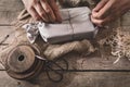 Man is wrapping a gift with natural materials and organic cotton, ecological and biodegradable Royalty Free Stock Photo