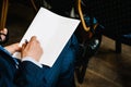 A man writes a pen on a blank sheet of paper. Place for text. hands of a businessman in a suit signing or writing a document on Royalty Free Stock Photo