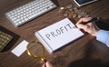 Man writes text Profit in notepad Royalty Free Stock Photo