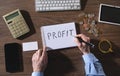 Man writes text Profit in notepad Royalty Free Stock Photo