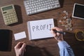 Man writes text Profit in notepad Royalty Free Stock Photo