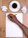 Man writing on a blank piece of paper