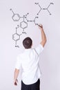 Man writing chemical formulas on the wall Royalty Free Stock Photo