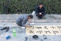 Man writing Chinese calligraphy