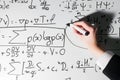 Man writing complex math formulas on whiteboard. Mathematics and science Royalty Free Stock Photo