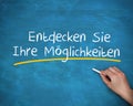 Man writing entdecken sie ihre moglichkeiten with a chalk Royalty Free Stock Photo