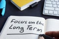 Man is writing focus on the long term. Royalty Free Stock Photo