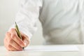 Man writing with a fountain pen on blank paper Royalty Free Stock Photo