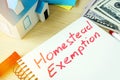 Man writing Homestead Exemption in a note.