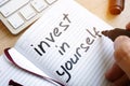 Man is writing invest in yourself. Royalty Free Stock Photo
