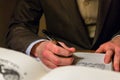 Man writing a letter in a journal