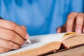 Man writing note in old book Royalty Free Stock Photo