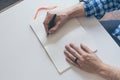 man writing in notebook with fountain pen on white table Royalty Free Stock Photo