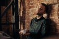 Man writing on an old typewriter. In the meantime, he drinks coffee Royalty Free Stock Photo