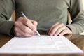 Man Writing on Paper with Pen on Table Royalty Free Stock Photo