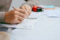 Man writing a payment check at the table with calculator and sta Royalty Free Stock Photo