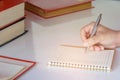 Man writing pen in book on white table Royalty Free Stock Photo