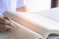 Man writing pen in book on white table Royalty Free Stock Photo