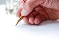 Man writing with pen on paper, close up of hand hollding pen to write on paper document Royalty Free Stock Photo