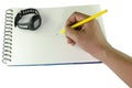 Man writing with a pencil on a spiral bound book and wrist watch Royalty Free Stock Photo