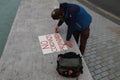 Man Writing a Protest Sign