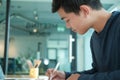 Man writing reminder note. male freelancer student working organizing plan at workplace Royalty Free Stock Photo